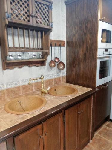 a kitchen counter with two sinks in a kitchen at Casa Candela in Ronda
