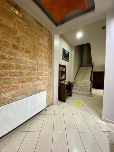 a hallway with a stone wall and stairs at Ξενοδοχείο Acropol in Larisa