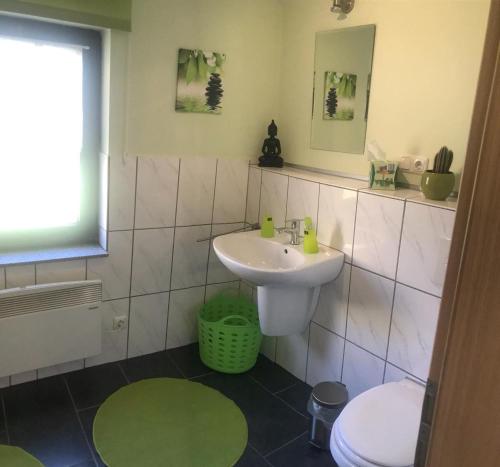 a bathroom with a sink and a toilet at Ferienhaus im Ostertal in Sankt Wendel