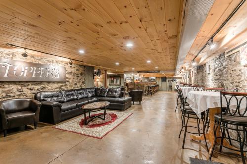 a restaurant with a leather couch and tables and a bar at Naples Hotel in Naples