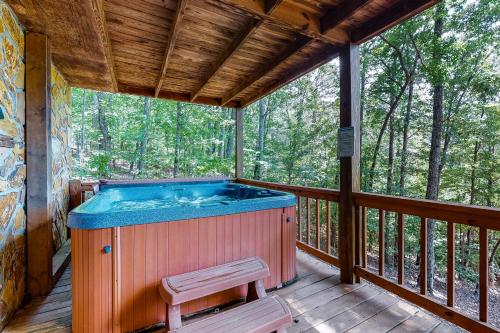 a hot tub on the deck of a cabin at A Heavenly View in Blue Ridge