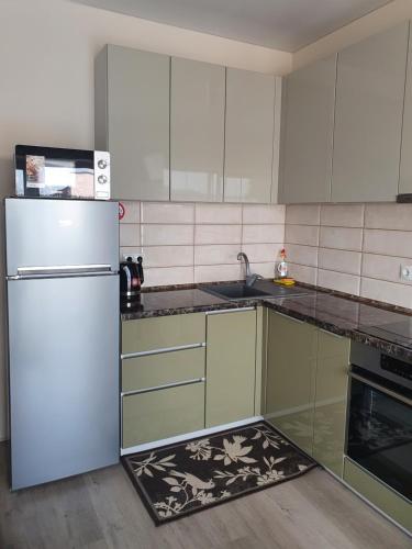 a kitchen with a refrigerator and a sink at квартира в центрі міста, новобудова in Luts'k