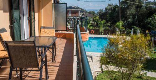 a balcony of a house with a swimming pool at Nature & Blue in Parga