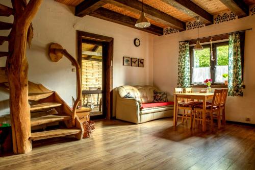 a living room with a couch and a table at Wiejski Dworek in Solina