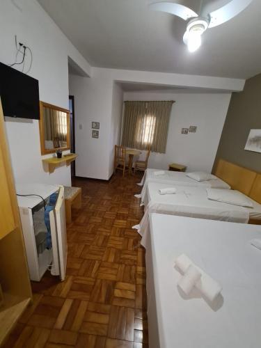a room with a bunch of beds in it at VITORIA GARDEN in Águas de Lindóia