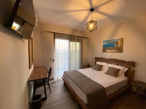 阿莫利亞尼島的住宿－Escape at Ammouliani，一间卧室配有一张床、一张桌子和一个窗户。