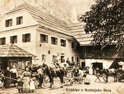an old photo of a horse drawn carriage in front of a building at Frida's Old House in Bled