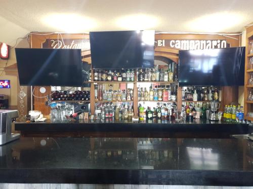 a bar with a lot of bottles of alcohol at Hotel Posada Santa Fe Sabinas in Sabinas