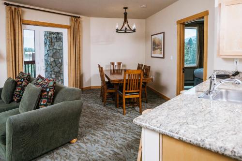 a kitchen and living room with a couch and a table at Juniper Springs Resort in Mammoth Lakes