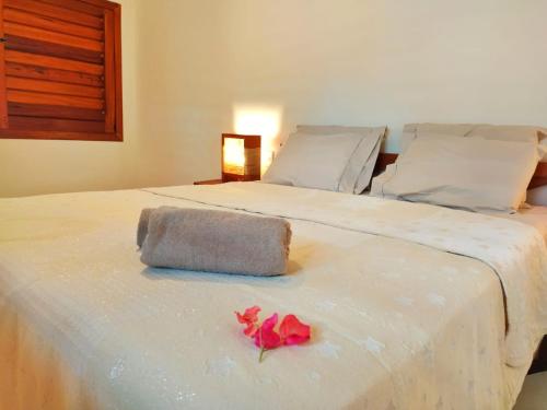 伊卡萊的住宿－Villa Pitaya，一张白色的床,上面有玫瑰花