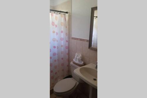 a bathroom with a toilet and a sink at 3 rooms house in Managua