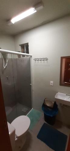 a bathroom with a shower and a toilet and a sink at Suites em Floripa in Florianópolis