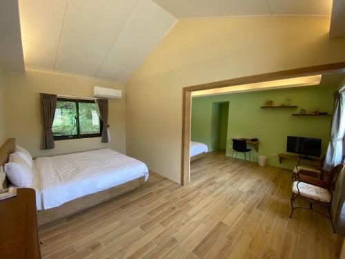 une chambre avec un lit et une télévision dans une pièce dans l'établissement 南庄拾光民宿, à Nanzhuang