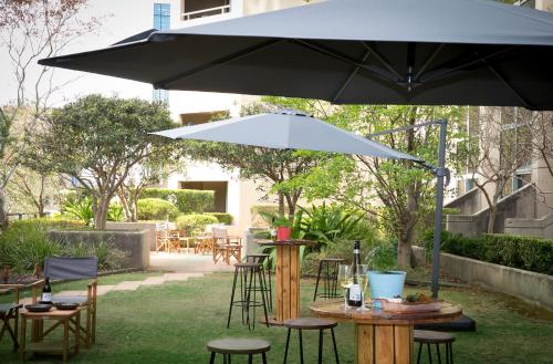 an umbrella sitting on top of a table with chairs at Sydney Central Hotel managed by The Ascott Limited in Sydney