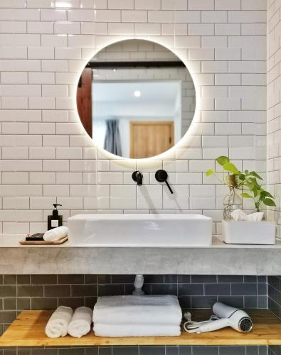 a bathroom with a sink and a mirror at Hotel AONO in Chiang Mai