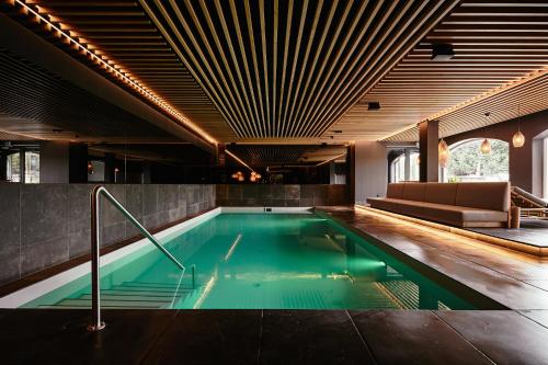 a swimming pool with green water in a building at Hotel Gerl in Salzburg