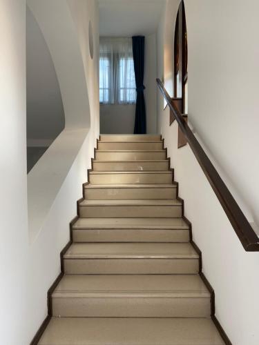 a staircase in a house with white walls at Villa Campana in Siófok