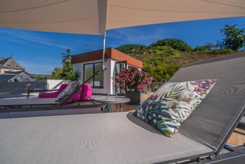 a bed with a pillow sitting on a patio at Hotel Lipmann "Am Klosterberg" in Beilstein