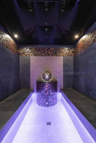 a room with purple lighting and a table in the middle at Hotel Lipmann "Am Klosterberg" in Beilstein
