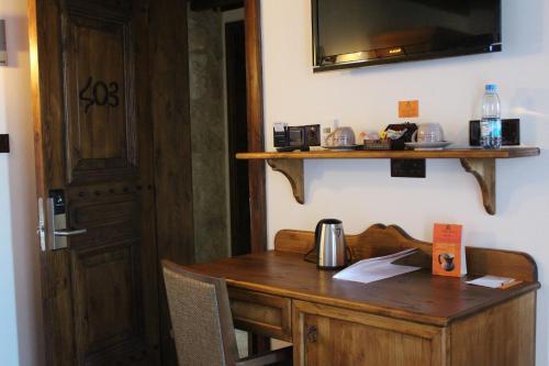 a wooden table topped with a coffee cup and a microwave at Kemerli Konak Boutique Hotel in Kyrenia