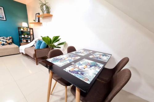 a dining room with a table and chairs at Cozy Space Near SM with Netflix and Fiber WiFi in Batangas City