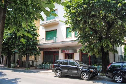 a black suv parked in front of a building at Hotel Brasile in Montecatini Terme