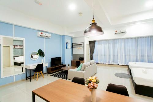 a living room with a couch and a table at Revo Pavilion Bukit Jalil by Ody Suites in Kuala Lumpur