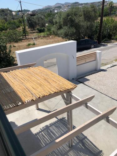 a picnic table and bench on the roof of a house at Oliva in Faliraki