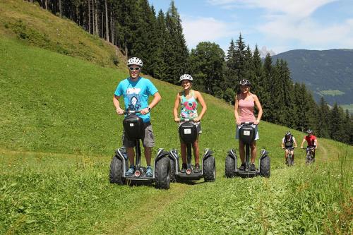a group of people riding on four wheeler on a hill at Appartement Fritzenwallner in Wagrain