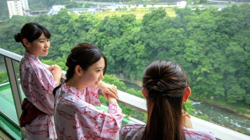 two girls in kimonos looking out of a window at Kinugawa Hotel Mikazuki in Nikko