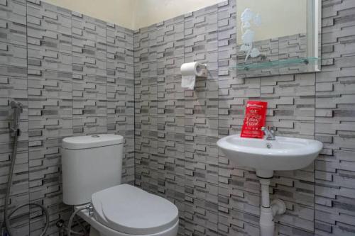 a bathroom with a toilet and a sink at RedDoorz @ Jalan Raya Kaliwungu Selatan Kendal in Kendal