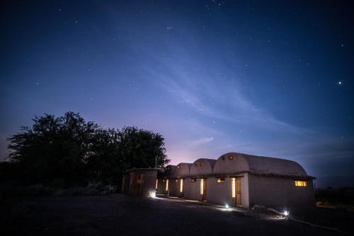a building with lights on it at night at Planeta Atacama Lodge in San Pedro de Atacama