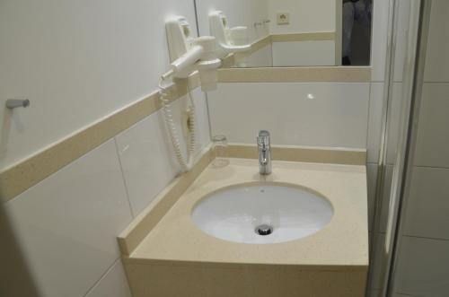 a bathroom with a sink and a mirror at Hotel Amba in Munich