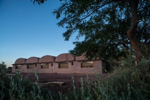 an old building in the middle of a field at Planeta Atacama Lodge in San Pedro de Atacama