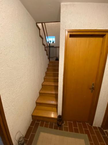 a hallway with a staircase with a wooden door at SanMari_forest in Ledenice