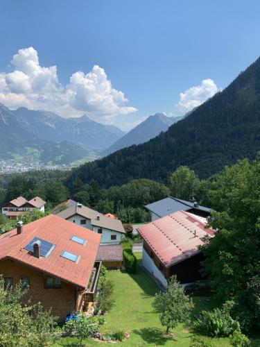 a group of buildings with mountains in the background at Bellevue Apartments in Bürserberg