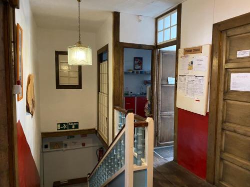 a hallway with a staircase in a room with a door at Pension La Cubana in Santa Cruz de la Palma