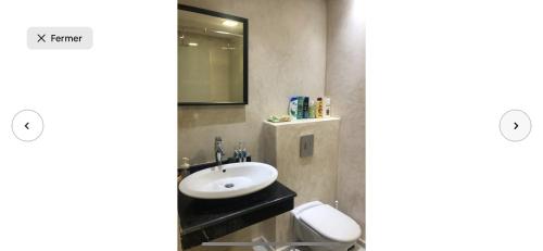 a bathroom with a sink and a mirror at Villa moderne avec piscine, front de mer in Casablanca