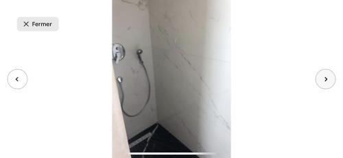 a bathroom with a shower in a white wall at Villa moderne avec piscine, front de mer in Casablanca