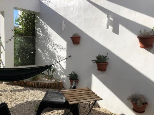 a hammock in a courtyard with potted plants at Villa moderne avec piscine, front de mer in Casablanca