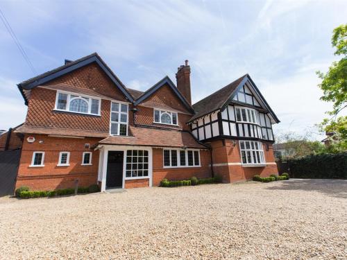 a large brick house with a large driveway at Verve Hotel in Bedford