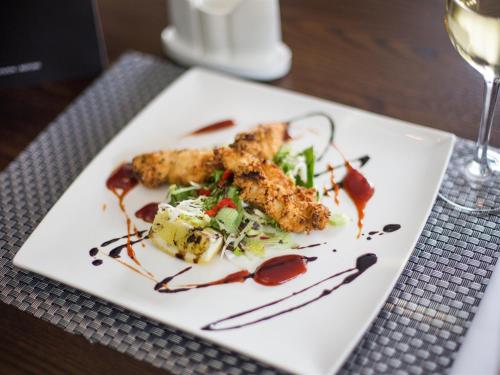 a white plate with food on a table at Verve Hotel in Bedford