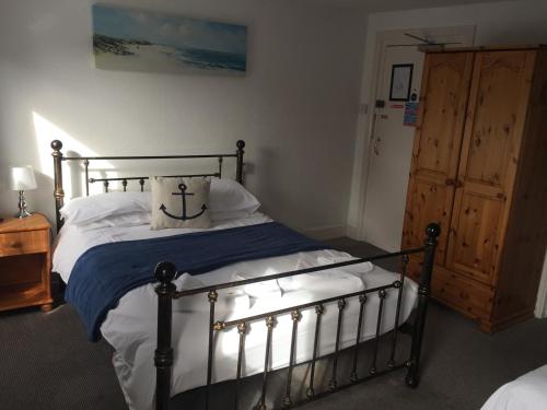 a bedroom with a metal bed with a pillow on it at The Victoria Hotel in Burnham on Sea