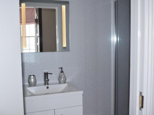 a bathroom with a sink and a mirror at The View on the terrace in Weymouth