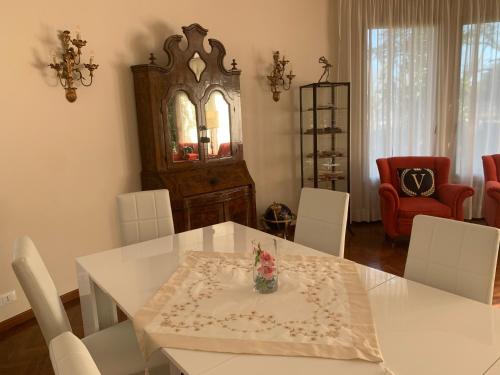 a dining room with a white table and white chairs at Villa Mase in Ravenna