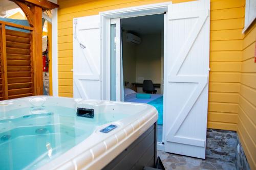 a bathroom with a white sink and a sliding door at Villas Ixora in Sainte-Anne