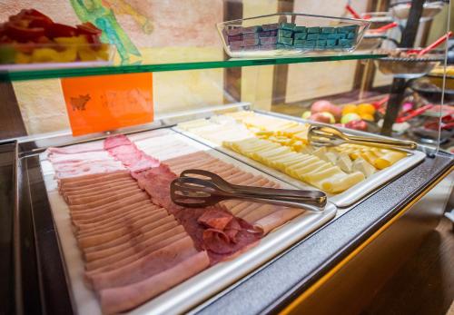 a display case with different types of meats and cheese at Hotel U Malého Vitka in Český Krumlov