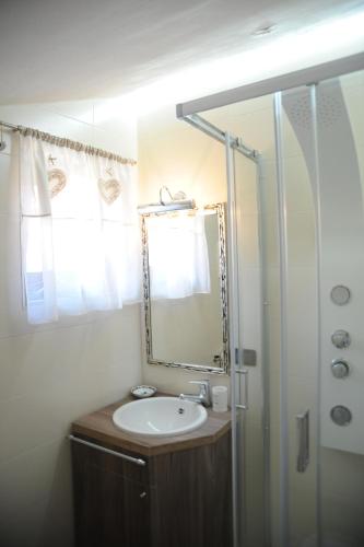 a bathroom with a sink and a mirror at RESIDENZA D'ORIA B&B in Foggia
