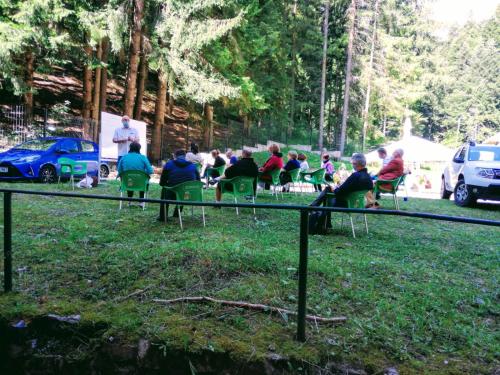 a group of people sitting in chairs in a park at HOSTEL CPPI Nord in Buşteni