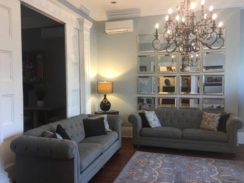 a living room with a couch and a chandelier at WG Creole House 1850 in New Orleans